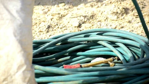 A worker with protective clothes and gloves coiling the hose Stock-Footage 116506714