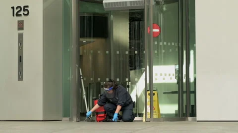 Worker in Protective Face Shield and Rubber Gloves Cleaning Office Building Vídeos de archivo 140884178