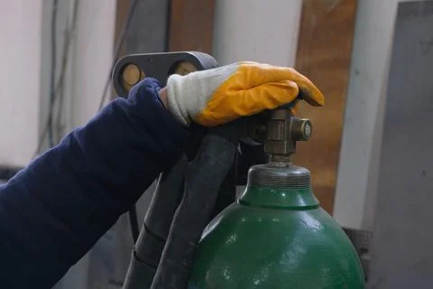 Worker in Protective Glove Operating Valve on Industrial Gas Cylinder Stock Photos