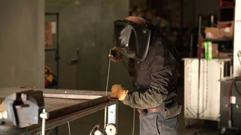 Worker in protective helmet using cold welding for repairing an object Stock Footage 241818206