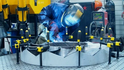 Worker in protective mask making weld of industrial unit. Welding process Stock Footage 111983459