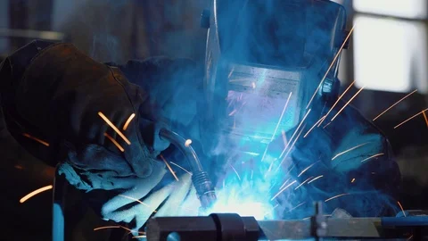 Worker in protective mask uses gas welding torch to connect seam of metal part Stock Footage 110703033