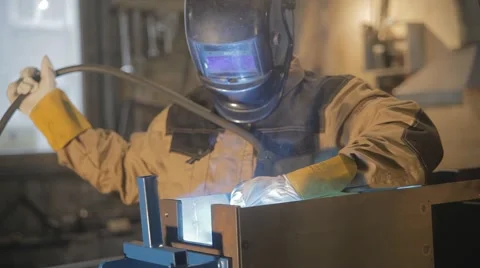 Worker with protective mask welding metal Stock Footage 65300940