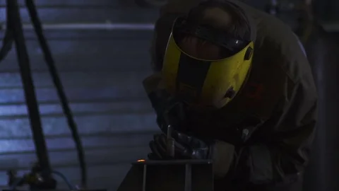 Worker with protective mask welding metal. Slowmo Video stock 72942590