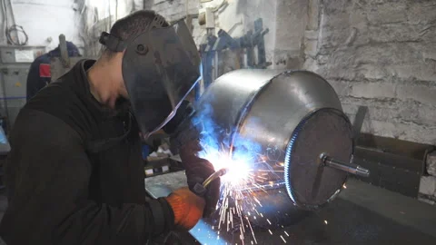 Worker in protective mask welding metal construction at metalworking factory Stock Footage 235985273