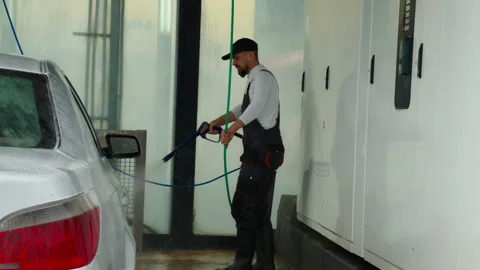 Worker in protective overalls meticulously use high-pressure water jet to c.. Stock Footage 320889720