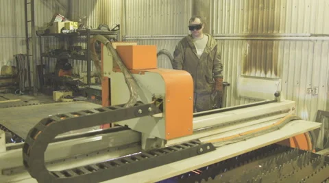Worker in protective suit and glasses oversees work of plasma machine Stock Footage 63998287