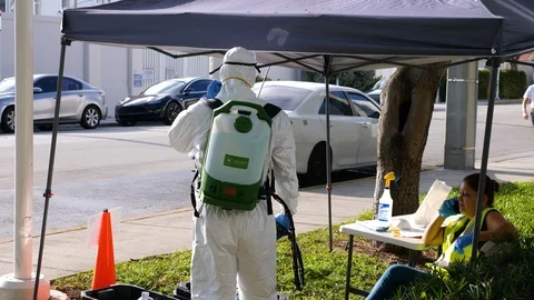 Worker in protective suit to clean bus against covid-19 coronavirus disease Stock Footage 126584205