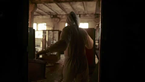 Worker in protective suit inside the ruined building exploring abandoned area Video stock 161304604