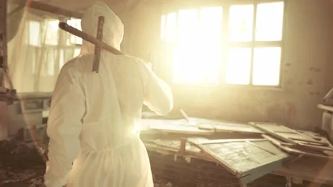 Worker in protective suit inside the ruined building exploring abandoned area Video stock 161650330