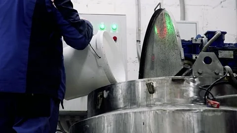 Worker in a protective suit while working with equipment at a modern chemical Видео 205554807