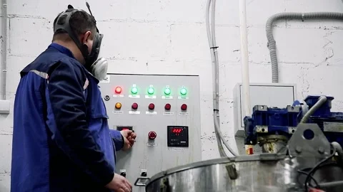 Worker in a protective suit while working with equipment at a modern chemical Stock Footage 209146015