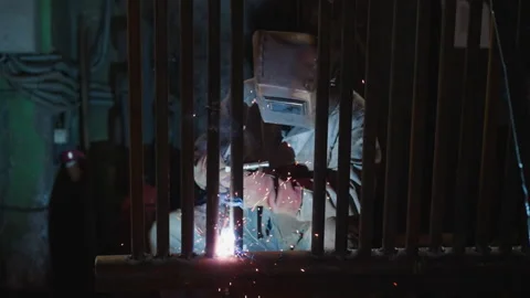 Worker in protective uniform welds pipeline for boiler house Stock-Footage 243305050