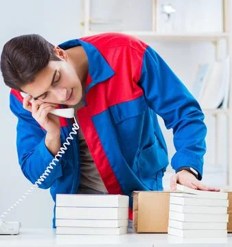 Worker in publishing house preparing book order Stock Photos