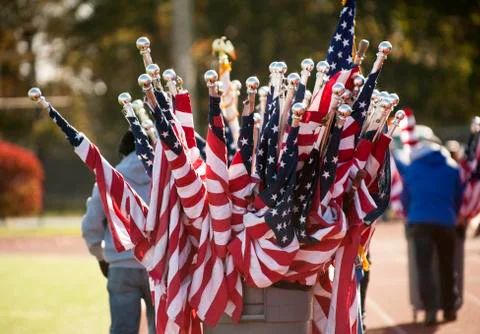 Worker pulling barrel full of American flags Fotos de archivo