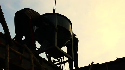 Worker pulling cement on construction site Stock Footage 155792617