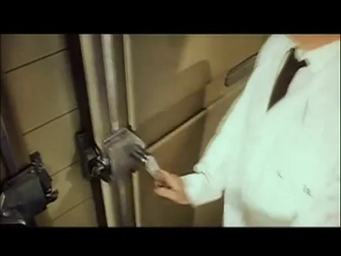 Worker pulling open mortuary refrigerator door, 1960s Stock Footage 61444953