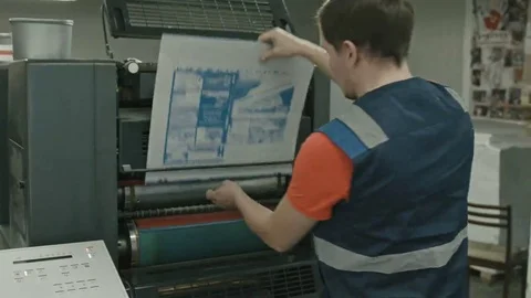 Worker pulls on the blank printable on polygraph industry process, color Stock Footage 69093273