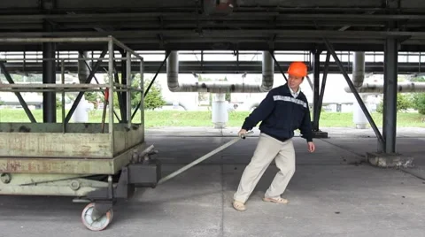 Worker Pulls Cart Stock Footage 8659474
