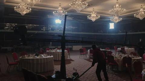 Worker pulls construction with camera along empty restaurant Stock Footage 219803937