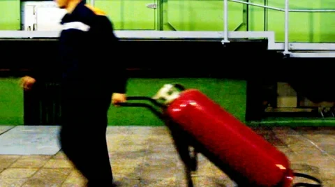Worker Pulls Fire Extinguisher Stockbeeldmateriaal 10804679