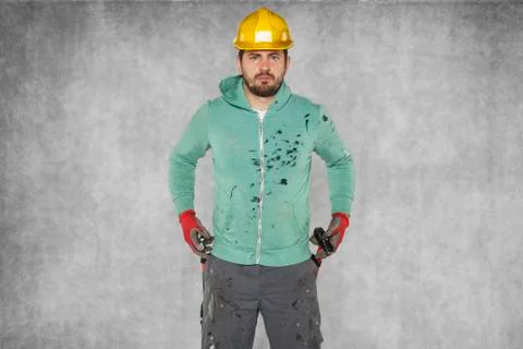 The worker pulls the hammer out of his trousers Stock Photos