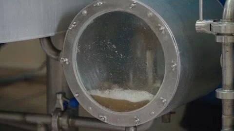 Worker Pulls Lever On Valve Of Production Container Equipment Filled With Ale Stock Footage 280198491