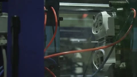 A worker pulls out a part from the plastic hot casting machine Stock Footage 160504029