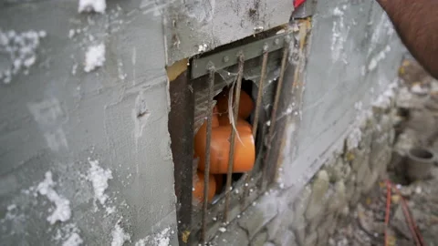 Worker pulls a window out of the concrete wall with crowbar Stock Footage 158979985