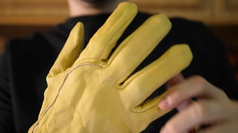 Worker Pulls Yellow Gloves away, remove from Hands. Diy Carpenter taking it off. 库存影片 129461355