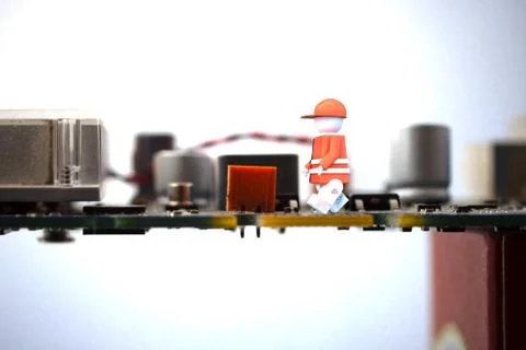 Worker puppet on a computer motherboard Illustrazione stock