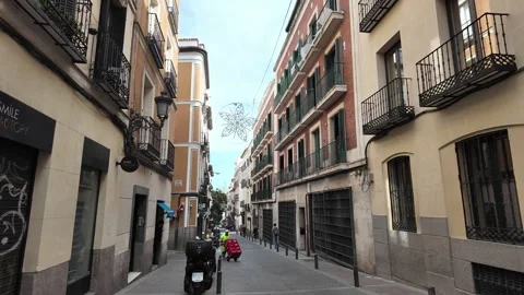 A worker pushing a cart of products down an empty street. Stock Footage 293016773