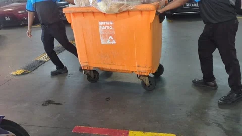 Worker Pushing Large Orange Trash Bin in Slow Motion. Stock Footage 328969489