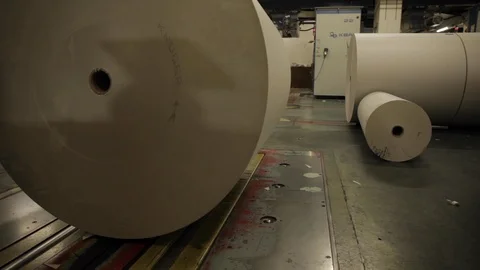 Worker Pushing Paper Roll on Track in Factory Stock Footage 113015555