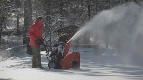 Worker pushing snow thrower after winter blizzard snowfall in residential area Video stock 35575290