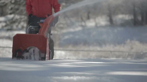 Worker pushing snow thrower after winter blizzard snowfall in residential area Video stock 35606253