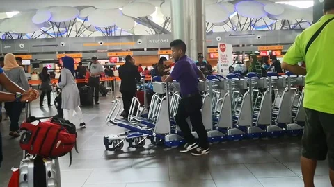 Worker pushing the trolley at airport Video stock 107465243