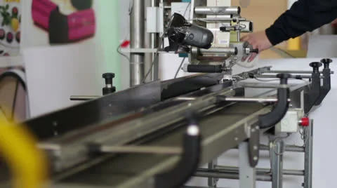 Worker puts bottles in the machine to label them Stock Footage 22555305