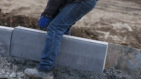 Worker puts a curb Stock Footage 58609702