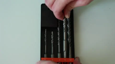 Worker puts a drill back into the pack Vídeos de archivo 65371196