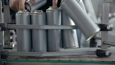 Worker puts empty spray cans on a pipeline in the factory Видео 117781169