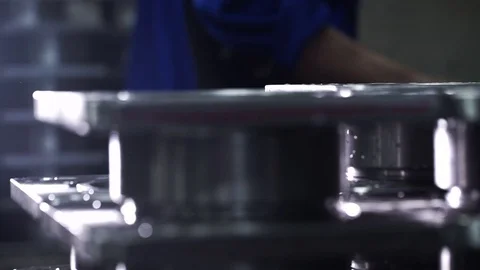 Worker puts the finished item in a stack of finished products Stock Footage 71506224