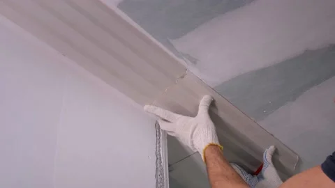 Worker puts fretwork on ceiling and makes marks with pencil Stock Footage 151545702