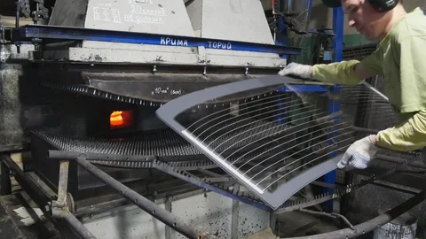 Worker puts the glass sheet on the frame.The production of stalinite. Stock Footage 122131872