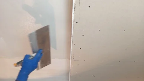 The worker puts the putty on the walls. It's equal, it's plastering Stock Footage 124226751