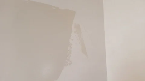The worker puts the putty on the walls. It's equal, it's plastering Stock Footage 124226874