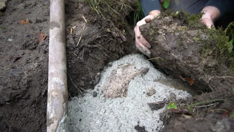 Worker puts rock into fresh concrete Stock Footage 158973790