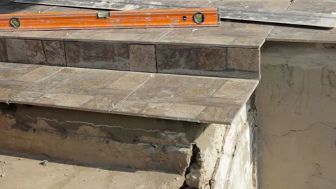 Worker puts the tile on the stairs Stock Footage 111648482