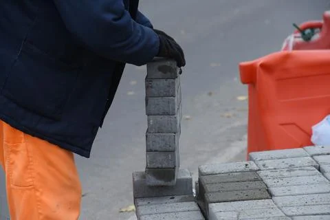 The worker puts tiles on top of each. Stock Photos