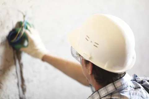 Worker puts the wires Stock Photos